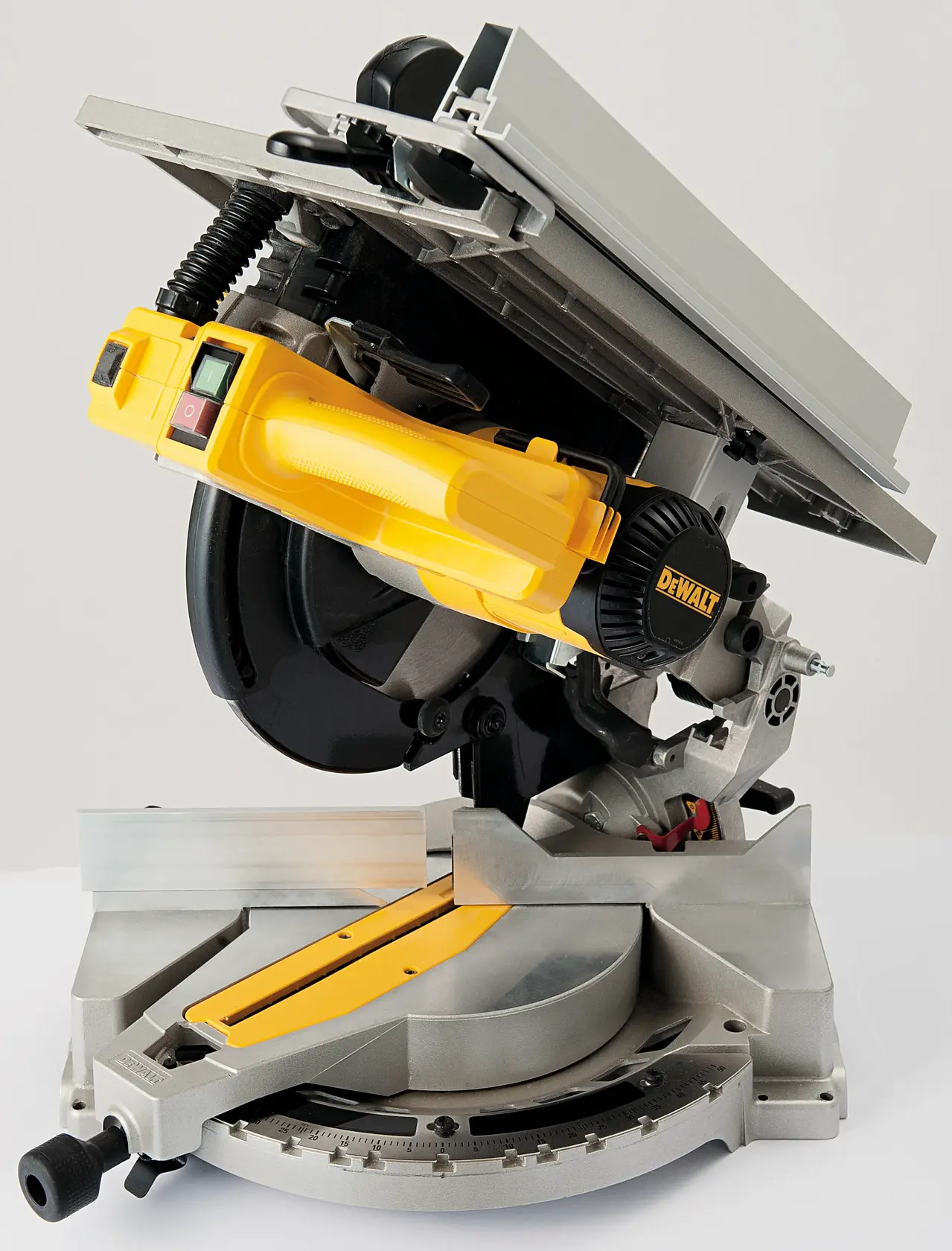 A DEWALT D27113 compound mitre saw with a yellow handle and a silver base. The saw is set in a tilted position, showing the blade, angle adjustment, and cutting platform.
