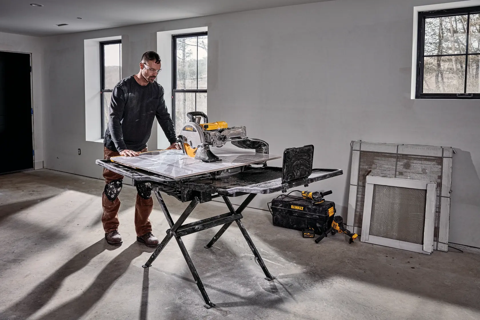 Photo of DEWALT tile saw D36000-QS, D36000 on stand in workspace, person working, photography product category.