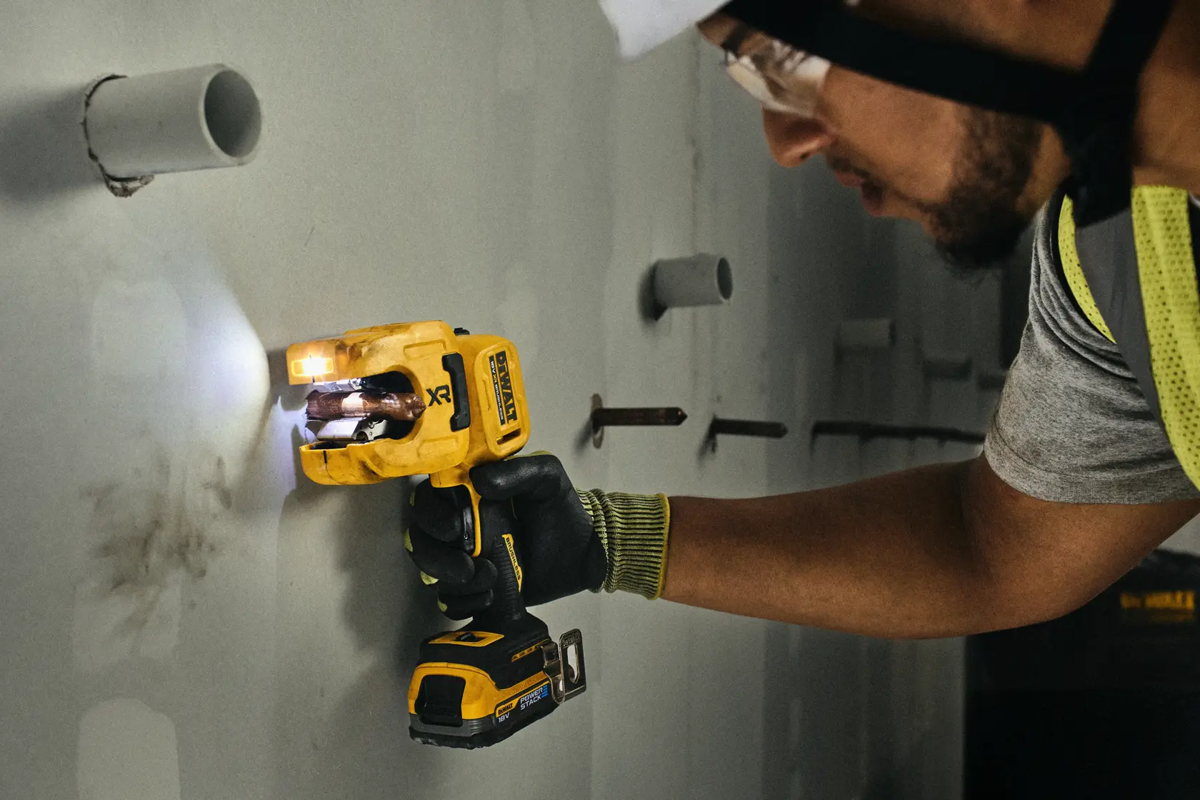 DEWALT DCE154N, DCE154N-XJ tool used on wall by worker; Photography category.