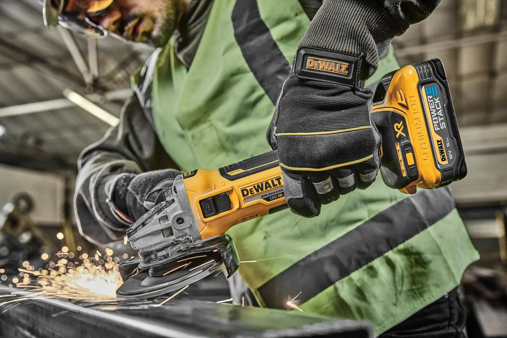 Person using a DEWALT cordless grinder on metal, sparks flying, in a workshop setting.