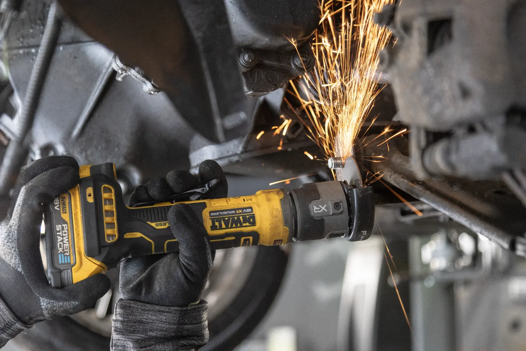 DEWALT DCG430N-XJ DCG430N angle grinder in use, cutting metal, sparks visible. SKU: DCG430N-XJ, DCG430N.