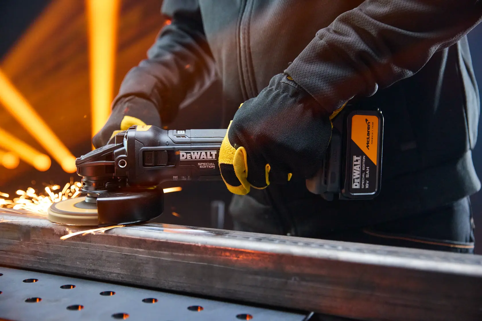 DEWALT grinder in use; sparks fly. Shown: DCG45MP2T-QW, DCG45MP2T. Photography product image.
