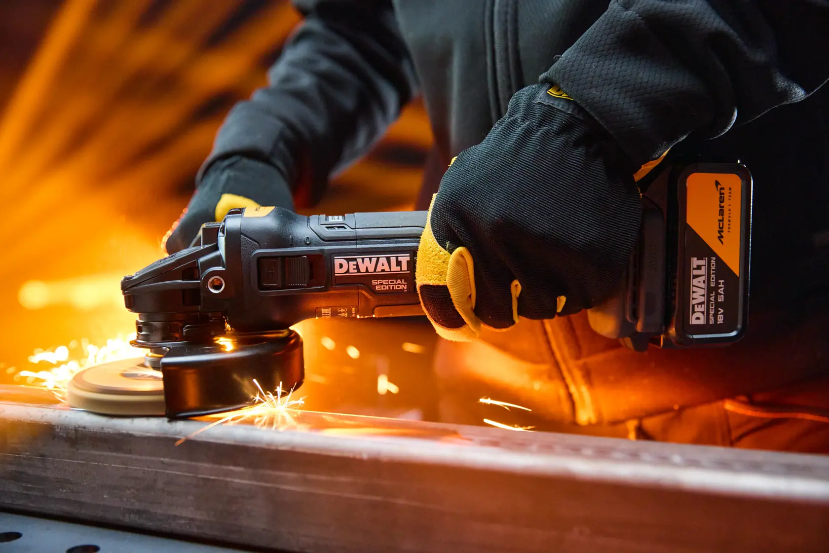 DEWALT grinder in use, model DCG45MP2T-QW and DCG45MP2T, with sparks flying during metal work.