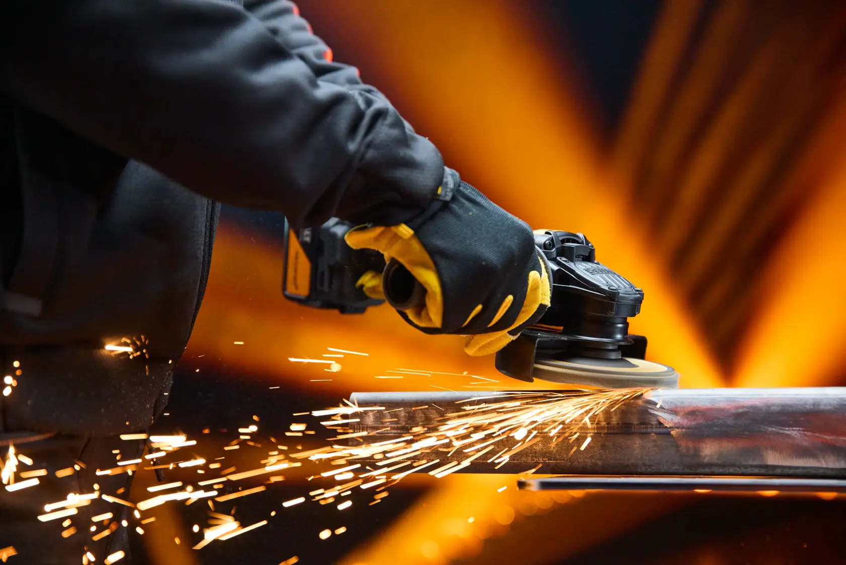 DEWALT DCG45MP2T-QW, DCG45MP2T grinder in use, sparks flying, close-up action, product category: Photography.