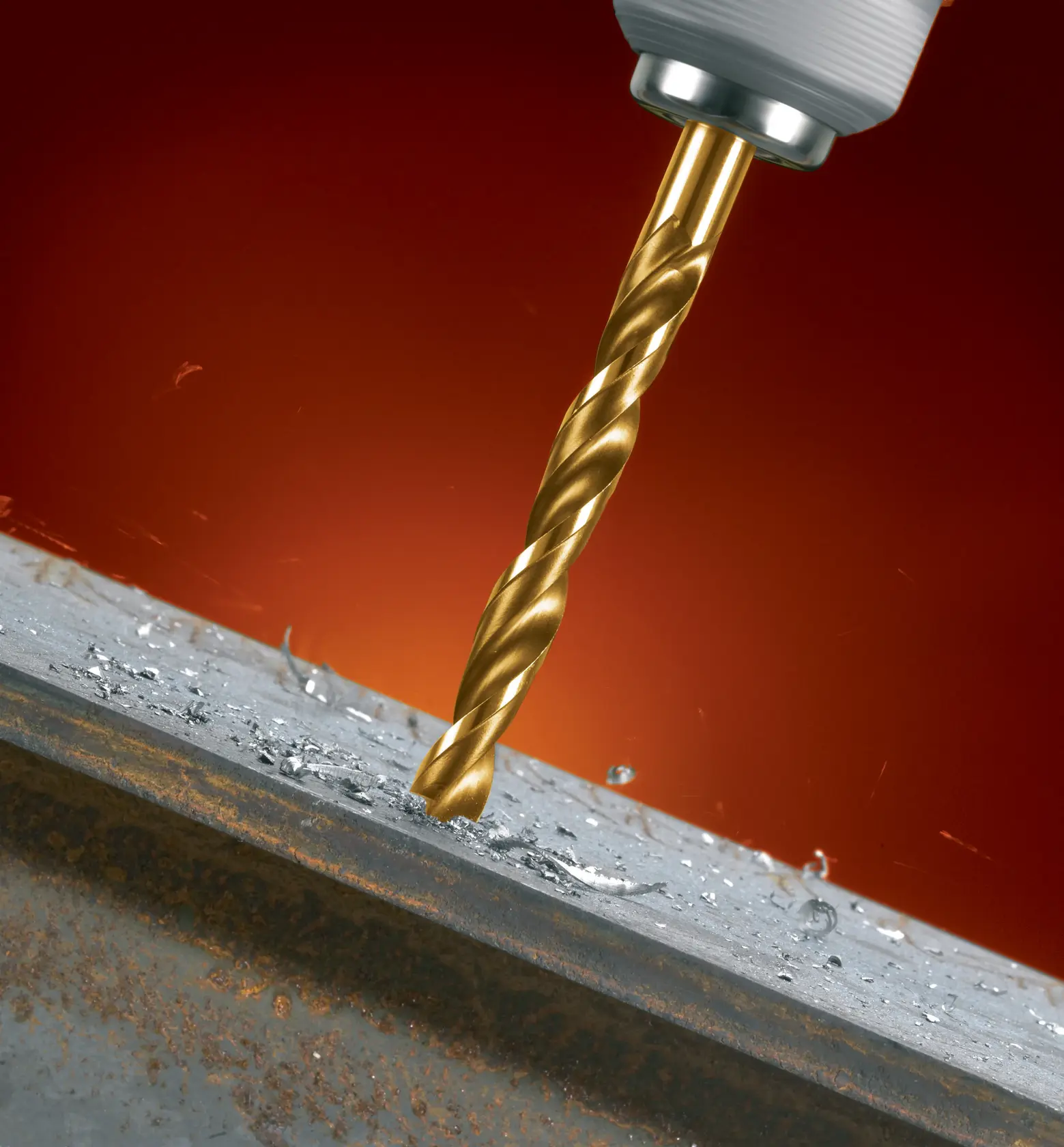 Primer plano de una broca DEWALT perforando metal, virutas de metal alrededor del agujero.