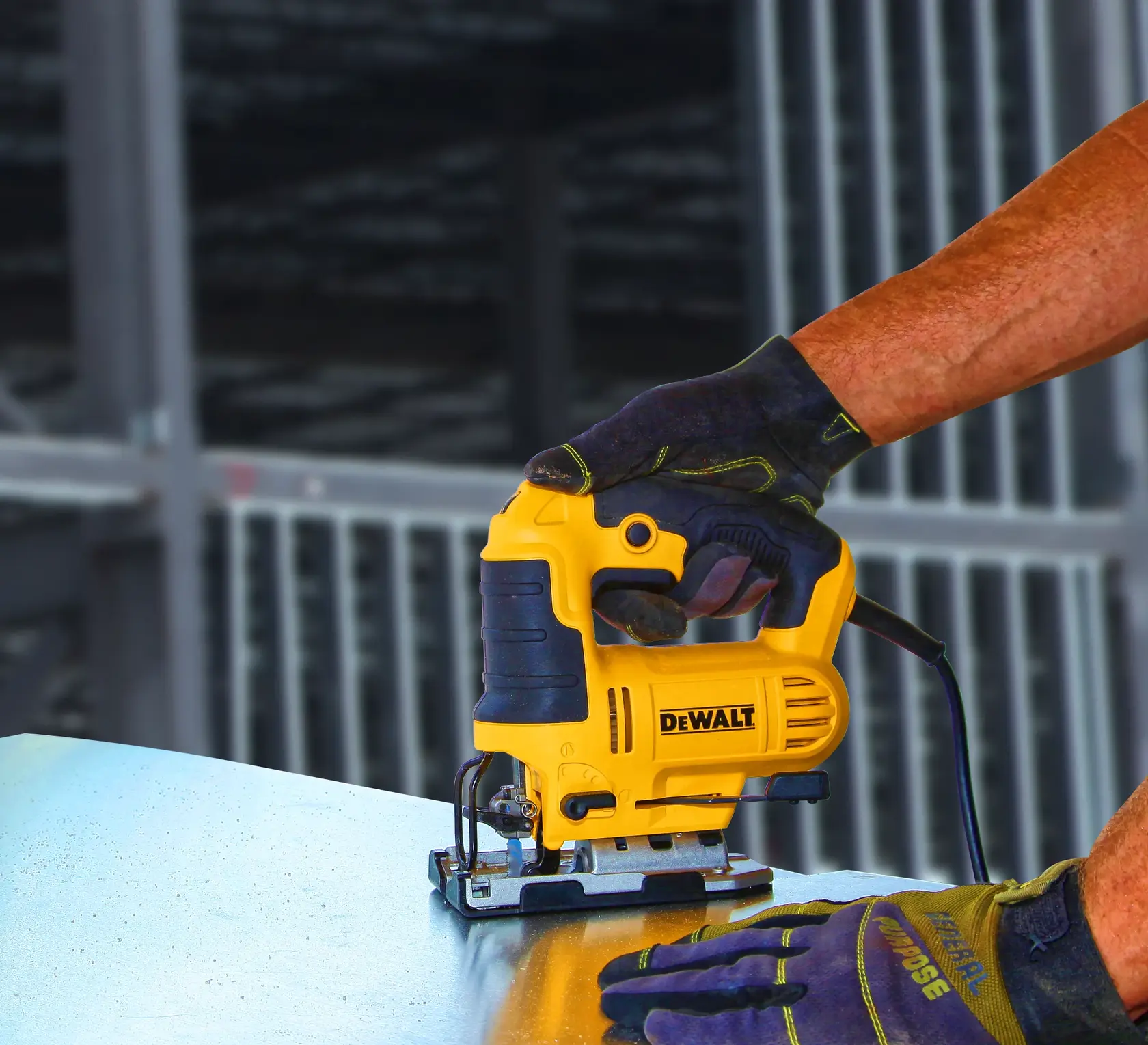 Photo of DEWALT DWE349 jigsaw cutting metal sheet, worker wearing gloves guides tool.